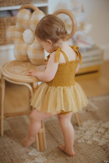 Wild Wawa Mustard Daisy Tutu on sweet baby girl from back