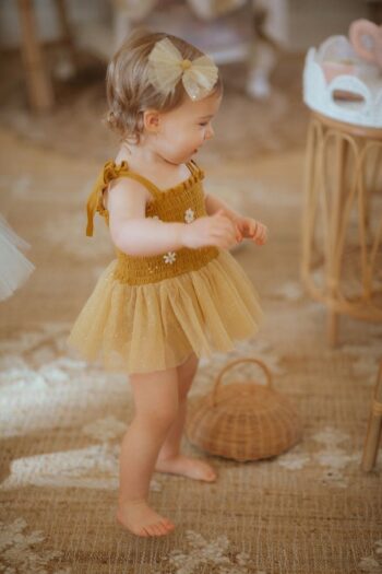 Wild Wawa Mustard Daisy Tutu on sweet baby girl side ways