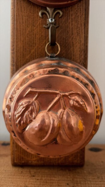 Vintage Copper Fruit Moulds on Wooden Rack Plum