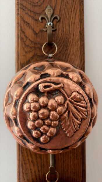Vintage Copper Fruit Moulds on Wooden Wall Rack